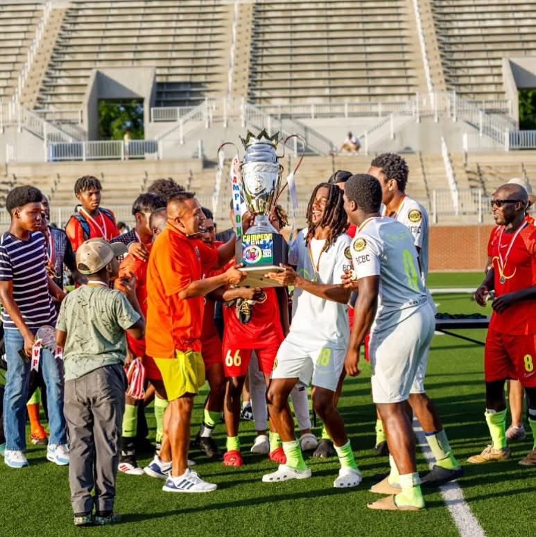 Champions lift the trophy on the field